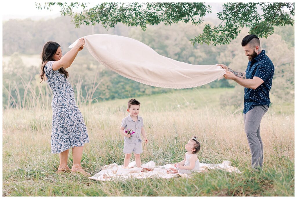 Family cuddling under trees during golden hour session