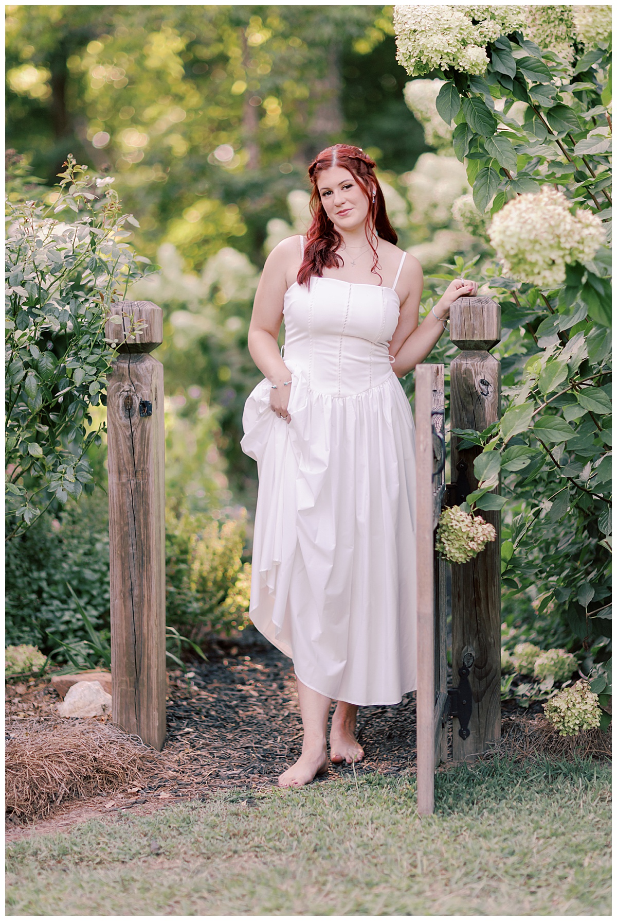 Addison in white corset dress in hydrangea garden at McGarity House senior session
