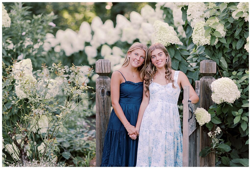 Sweet sibling moment with hydrangeas blooming behind