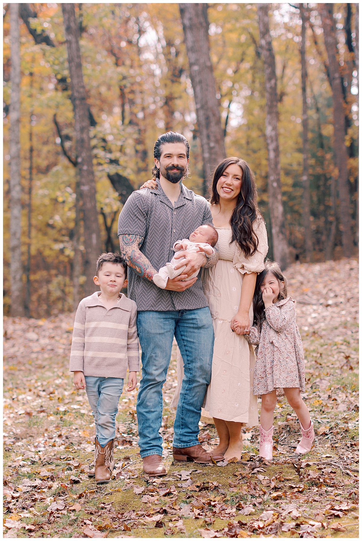Father holding newborn baby Wyatt outdoors beneath golden November leaves in Ellijay, Georgia.