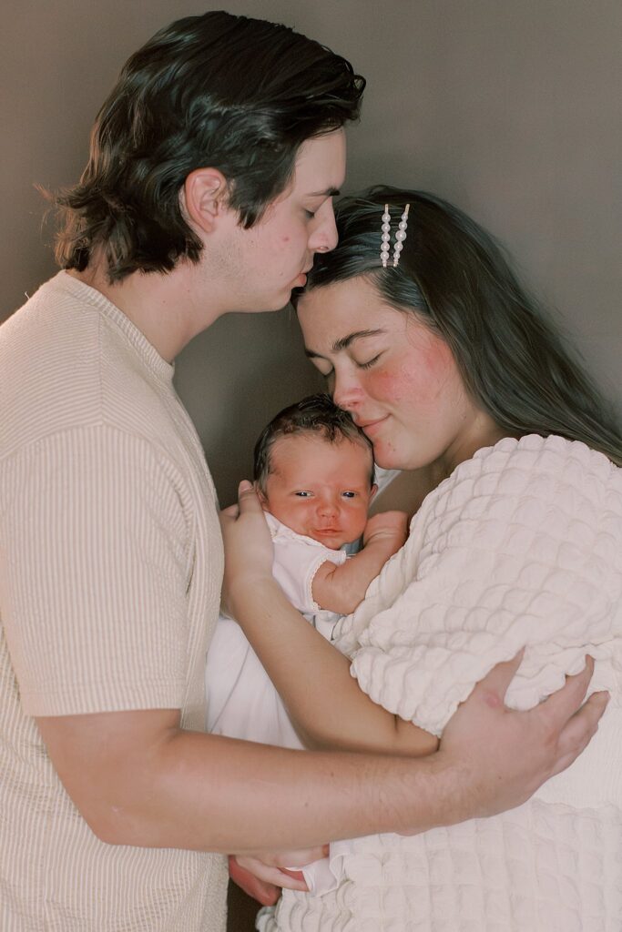 Adara and Grayson holding Wells together during their newborn session