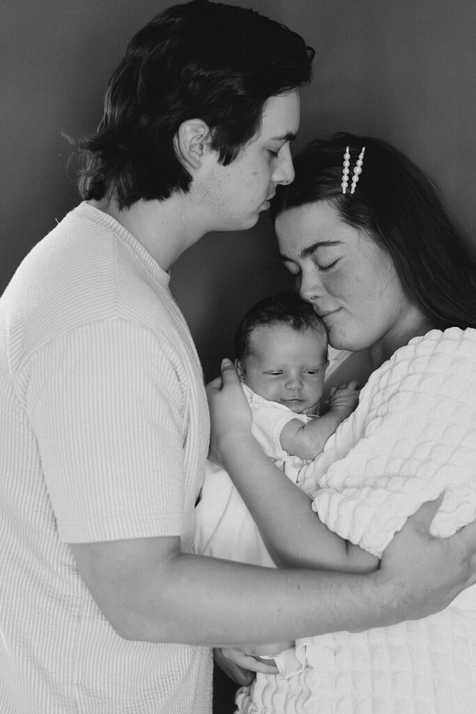 Adara and Grayson holding Wells together during their newborn session